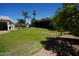 Beautiful backyard with lush green grass, a sparkling pool and privacy landscaping at 9505 E Jenan Dr, Scottsdale, AZ 85260