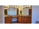 Bathroom featuring double vanities, granite countertops, and wooden cabinets at 9505 E Jenan Dr, Scottsdale, AZ 85260