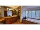 Luxurious bathroom with double vanities, a glass shower, and a soaking tub at 9505 E Jenan Dr, Scottsdale, AZ 85260