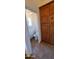 Bathroom with tile flooring, wooden cabinets, and a toilet behind an opened door at 9505 E Jenan Dr, Scottsdale, AZ 85260