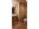 Bathroom features a pedestal sink, vanity lighting, toilet, and neutral paint at 9505 E Jenan Dr, Scottsdale, AZ 85260