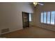 Bright bedroom features vaulted ceiling, window with shutters and mirrored closet doors at 9505 E Jenan Dr, Scottsdale, AZ 85260