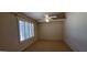 Bedroom features plush carpeting, fan and large window with white shutters at 9505 E Jenan Dr, Scottsdale, AZ 85260