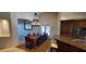Bright dining room featuring a wooden table, chandelier, and easy access to kitchen and backyard at 9505 E Jenan Dr, Scottsdale, AZ 85260
