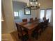 Charming dining area with a rustic wood table, chandelier, and open floor plan at 9505 E Jenan Dr, Scottsdale, AZ 85260