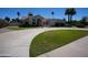 Elegant single-story home with a spacious driveway and manicured lawn at 9505 E Jenan Dr, Scottsdale, AZ 85260