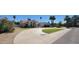 Beautiful single-story home with well-kept yard, mature palms, and a circular driveway at 9505 E Jenan Dr, Scottsdale, AZ 85260