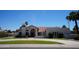 Stunning single-story home featuring a manicured lawn, desert landscaping, and a tiled roof at 9505 E Jenan Dr, Scottsdale, AZ 85260