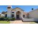Inviting home exterior featuring a covered entryway and well-maintained garden at 9505 E Jenan Dr, Scottsdale, AZ 85260