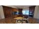 A detailed kitchen featuring dark wood cabinets, granite countertops, stainless steel appliances, and travertine floors at 9505 E Jenan Dr, Scottsdale, AZ 85260