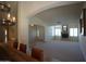 Open floor plan featuring fireplace, front door and view to dining at 9505 E Jenan Dr, Scottsdale, AZ 85260
