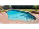 Inviting pool with steps is surrounded by a brick patio and green lawn at 9505 E Jenan Dr, Scottsdale, AZ 85260