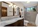 Updated bathroom featuring dual sinks, walk-in shower and modern fixtures at 9821 E Windrose Dr, Scottsdale, AZ 85260