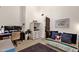 Bright bedroom featuring a comfy futon, large art and office desk at 9821 E Windrose Dr, Scottsdale, AZ 85260