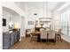 Bright dining room features a modern chandelier, wood table with upholstered chairs, and neutral decor at 9821 E Windrose Dr, Scottsdale, AZ 85260