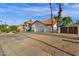 Lovely home with a tile roof, a three-car garage, mature landscaping, and a gravel driveway at 9821 E Windrose Dr, Scottsdale, AZ 85260