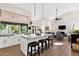 Open-concept kitchen features a large island with bar seating, modern appliances, and plenty of natural light at 9821 E Windrose Dr, Scottsdale, AZ 85260