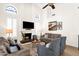 Bright living room with high ceilings, a fireplace, and comfortable seating arrangements at 9821 E Windrose Dr, Scottsdale, AZ 85260