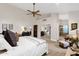 Bright main bedroom boasts a ceiling fan, an ensuite bath, and a walk-in closet at 9821 E Windrose Dr, Scottsdale, AZ 85260