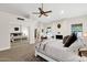 Spacious main bedroom featuring a fireplace, ceiling fan and carpet floors at 9821 E Windrose Dr, Scottsdale, AZ 85260