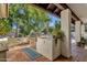 Outdoor kitchen area featuring built-in grill, counter space, and lush landscaping at 9821 E Windrose Dr, Scottsdale, AZ 85260