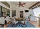 Inviting outdoor patio with a cozy dining area, stylish decor, and a mounted TV at 9821 E Windrose Dr, Scottsdale, AZ 85260