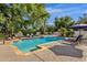 Beautiful backyard pool with lounge chairs and lush landscaping at 9821 E Windrose Dr, Scottsdale, AZ 85260