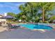Sparkling pool surrounded by a spacious deck and lush landscaping provides a perfect oasis for relaxation and fun at 9821 E Windrose Dr, Scottsdale, AZ 85260