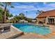 Sparkling pool surrounded by lush landscaping, creating a private and serene backyard oasis at 9821 E Windrose Dr, Scottsdale, AZ 85260