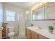 Functional bathroom featuring a shower, toilet, sink, and window with natural light at 1003 E Mariposa St, Phoenix, AZ 85014