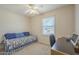 Cozy bedroom features a comfortable bed, a window with blinds, and a functional desk area at 1003 E Mariposa St, Phoenix, AZ 85014