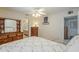Cozy bedroom featuring an ensuite bathroom, wood furnishings, and a ceiling fan at 1003 E Mariposa St, Phoenix, AZ 85014
