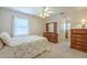 Comfortable bedroom featuring a ceiling fan, a large window, and a wooden dresser at 1003 E Mariposa St, Phoenix, AZ 85014