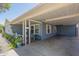 View of the carport featuring an outdoor living space with plants, and decorative home accents at 1003 E Mariposa St, Phoenix, AZ 85014
