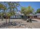 Charming home features desert landscaping, mature trees, and a covered porch with an attached carport at 1003 E Mariposa St, Phoenix, AZ 85014