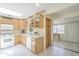 Functional kitchen featuring ample counter space, white appliances, a skylight, and wood cabinets at 1003 E Mariposa St, Phoenix, AZ 85014