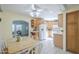 Bright eat-in kitchen with white appliances, wooden cabinets, tile floors, and a view into the living area at 1003 E Mariposa St, Phoenix, AZ 85014