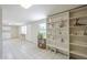 Spacious laundry room with white appliances, tiled flooring, and built-in shelving at 1003 E Mariposa St, Phoenix, AZ 85014