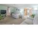 Bright living room with neutral carpet, white sofas, and an open layout leading to the kitchen at 1003 E Mariposa St, Phoenix, AZ 85014