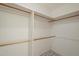 Spacious walk-in closet featuring wooden bars for hanging clothes and linoleum flooring at 1003 E Mariposa St, Phoenix, AZ 85014