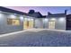 Modern stucco home with a gravel backyard, and views of the lighted exterior at 10637 N 16Th Ave, Phoenix, AZ 85029