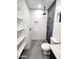 Modern bathroom with glass shower, rock floor, modern vanity, and shelving at 10637 N 16Th Ave, Phoenix, AZ 85029