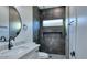 Bathroom with white vanity and contrasting dark tiled shower with rainfall showerhead at 10637 N 16Th Ave, Phoenix, AZ 85029