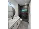 Modern bathroom featuring elegant vanity with sink and shower with dark tile accent wall at 10637 N 16Th Ave, Phoenix, AZ 85029