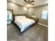 Bright bedroom featuring a plush bed, modern ceiling fan, and large mirror at 10637 N 16Th Ave, Phoenix, AZ 85029
