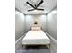 Cozy bedroom featuring a comfortable bed, a ceiling fan and minimal decor at 10637 N 16Th Ave, Phoenix, AZ 85029