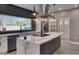 Modern kitchen features a spacious island with quartz countertop, stainless steel appliances and a large window at 10637 N 16Th Ave, Phoenix, AZ 85029