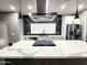 Modern kitchen showcasing a waterfall island, stainless steel appliances, and stylish pendant lighting at 10637 N 16Th Ave, Phoenix, AZ 85029