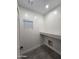 Bright laundry room with a small window and quartz countertop at 10637 N 16Th Ave, Phoenix, AZ 85029