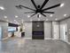 Modern living room featuring gray floors, sleek fireplace, recessed lighting, and an open floor plan connecting to the kitchen at 10637 N 16Th Ave, Phoenix, AZ 85029